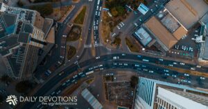 Aerial view of a busy city intersection with roads and buildings.