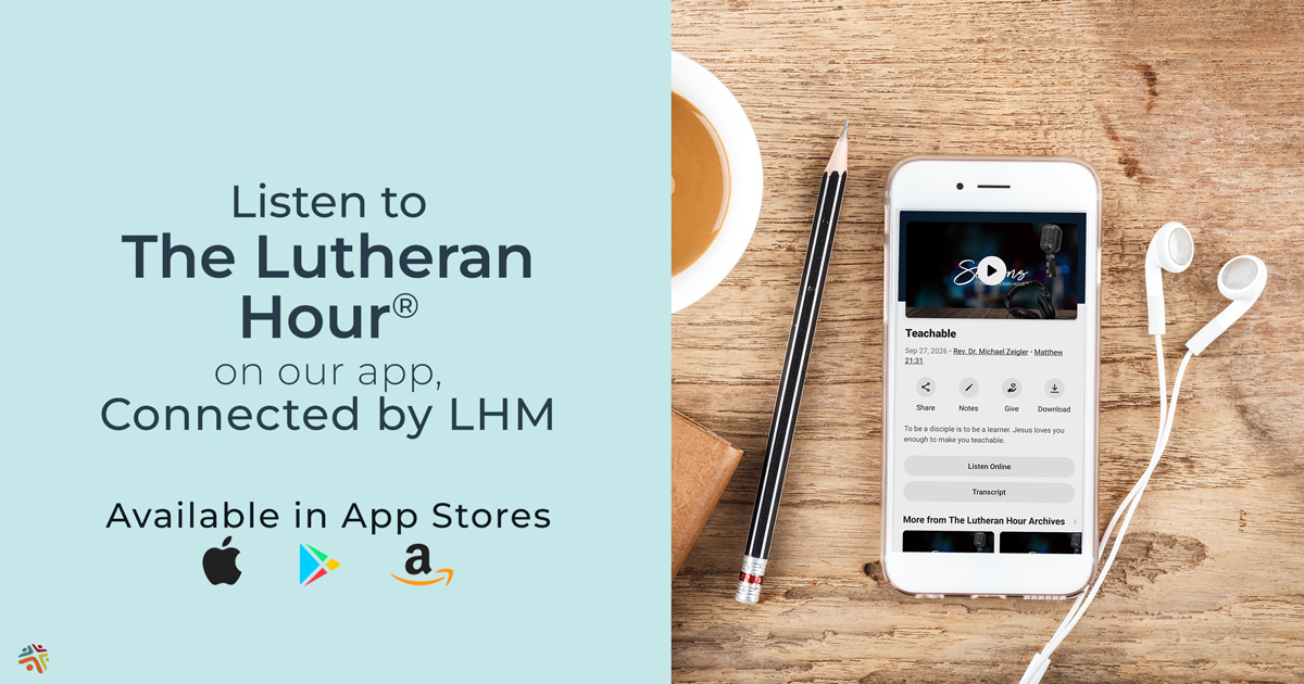 Smartphone displaying Lutheran Hour Ministries app with earphones and coffee.